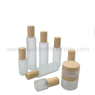 China Hot Items Frost Cylinder Glass Lotion Bottles With Wood Cap &amp; Glass Cosmetic Jars With Wood Cap supplier