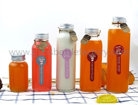 China 150ml,300ml,350ml,400ml,500ml New Items Clear Glass Juice Bottles With Silver Caps supplier