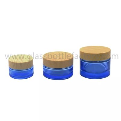 China 20g,30g,50g Blue Round Glass Cosmetic Jars With Wood Lids supplier