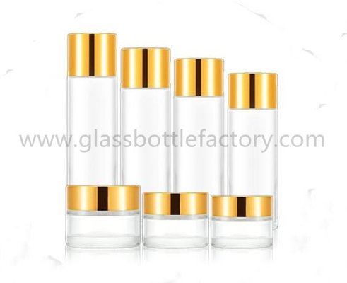 China 15ml,20ml,25ml,30ml,50ml,80ml,100ml,120ml,150ml Cylinder Glass Lotion Bottles &amp; 5g-100g Cosmetic Jars With Gold Lids supplier