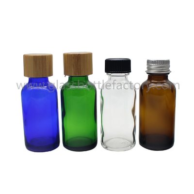China Clear,Amber,Blue and Green Colors Essential Oil Glass Bottles With Bamboo Caps supplier