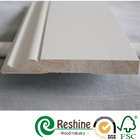 White primer coated pine and fir wood baseboard architrave mouldings